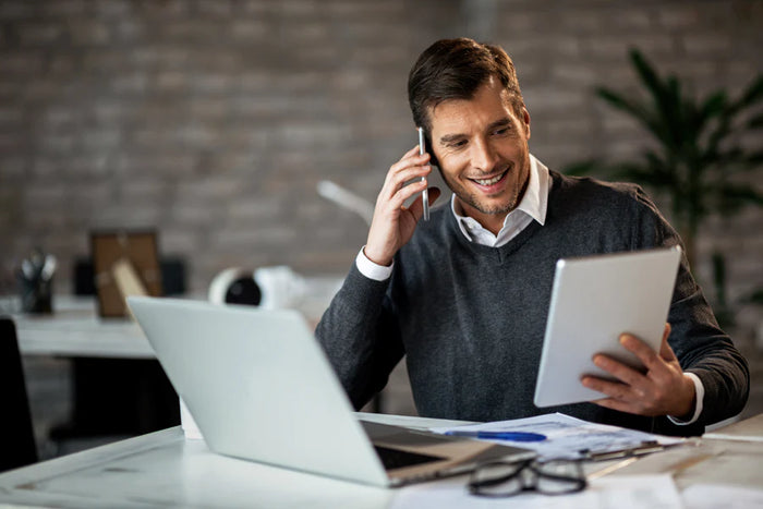 Man using tablet and laptop and smartphone